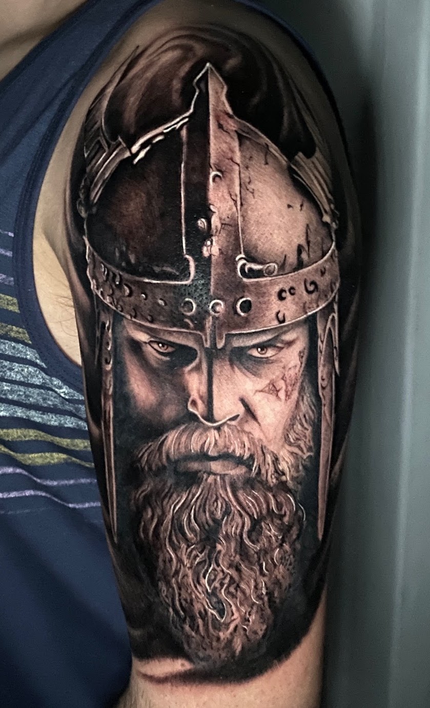 Black and grey Viking realism tattoo by Caos Art Tattoo Santiago