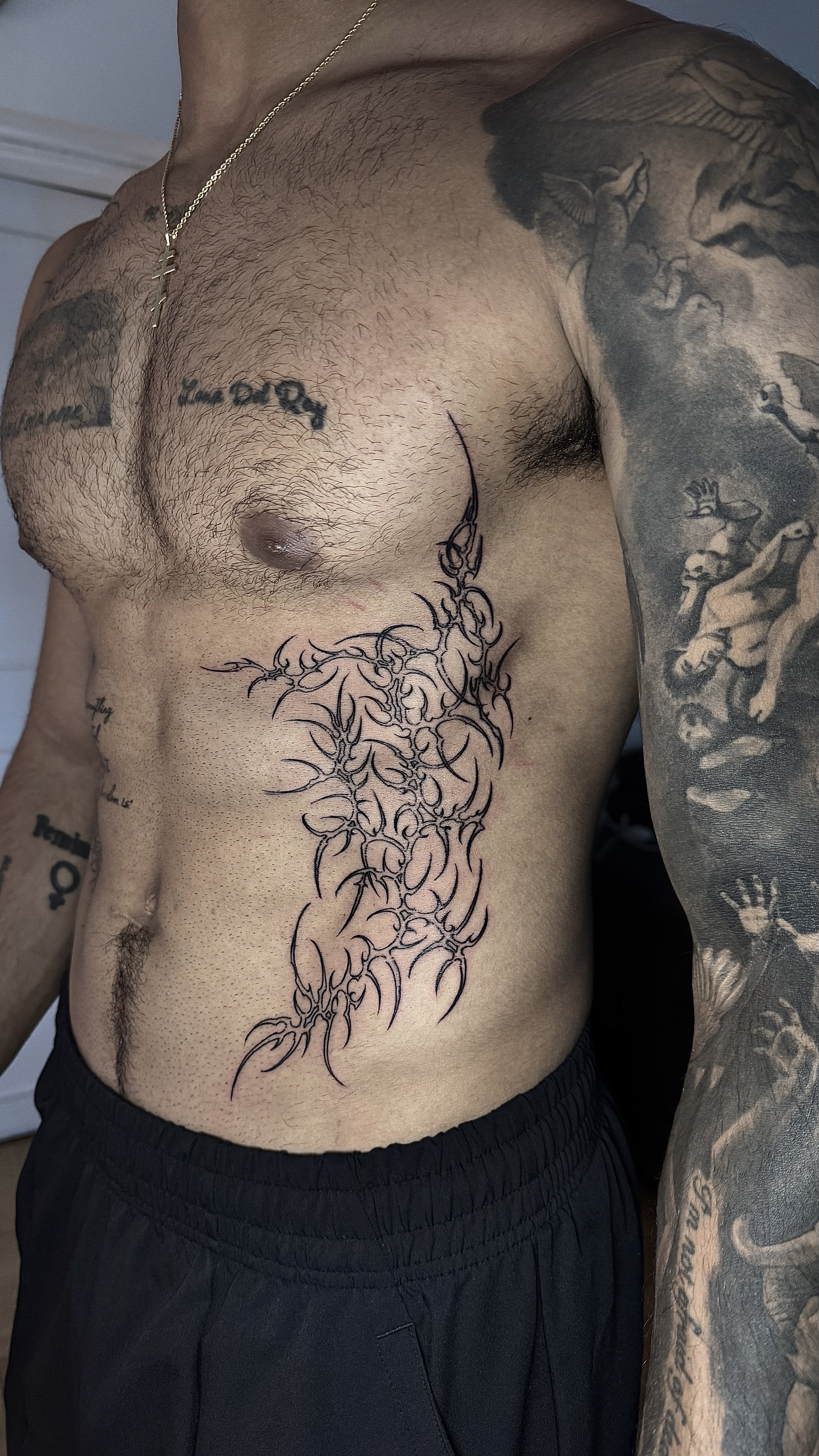 Tatuaje cyber sigilism blackwork torso costado orgánico — CAOS Art Tattoo Chile